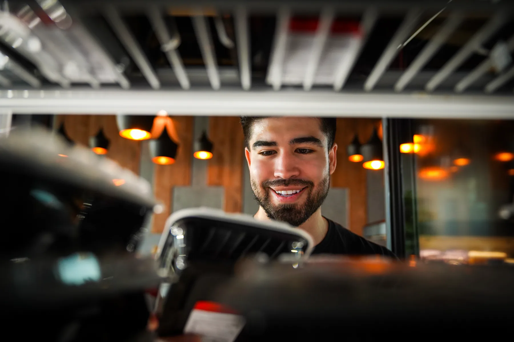 A customer choosing a packaged Fork to Fit meal from a store cooler