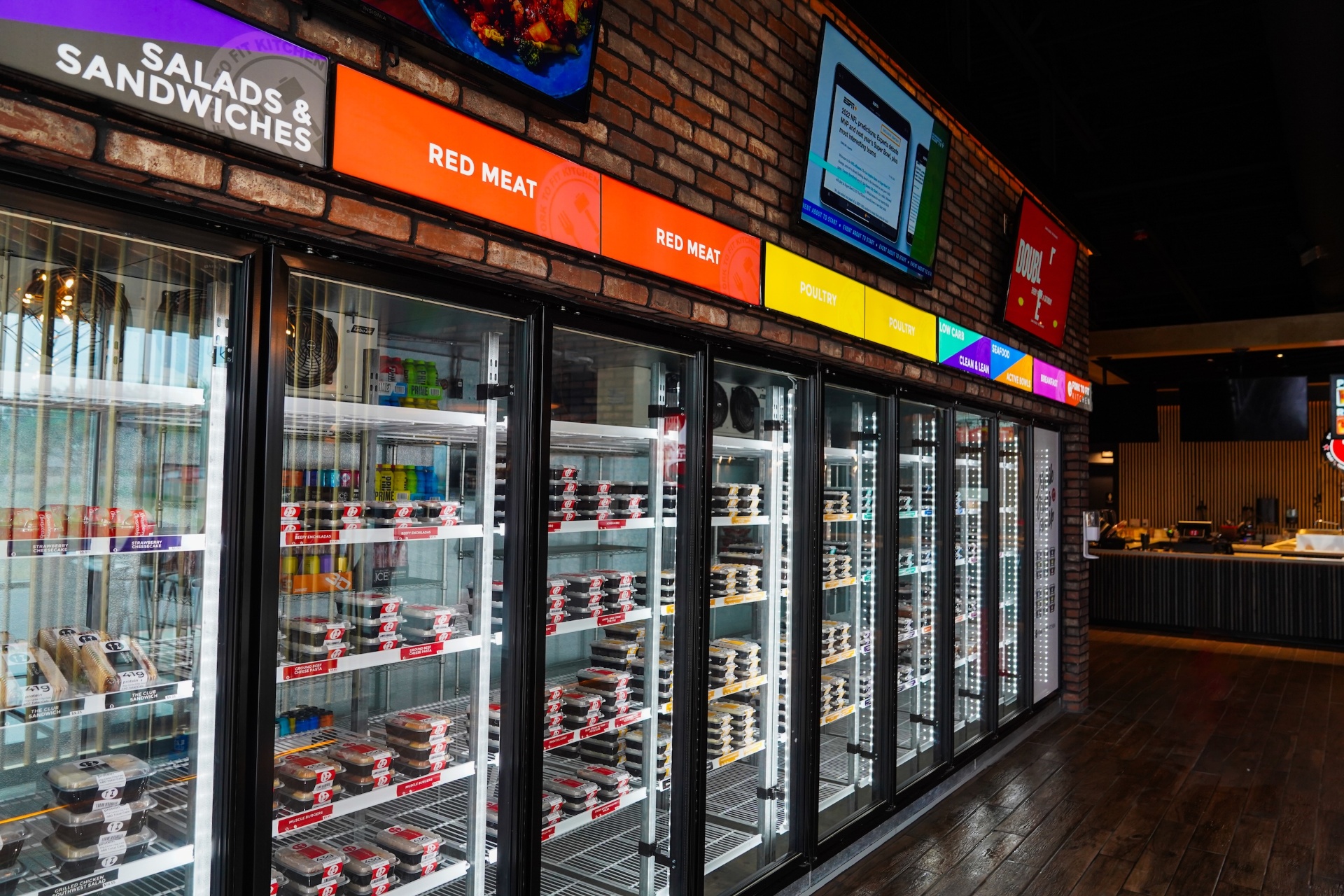A row of Fork to Fit retail coolers stocked with individually packaged meals